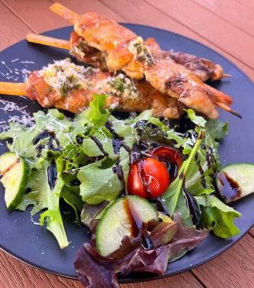 Plate of grilled skewers with a fresh salad, highlighting the variety of tasty dishes enjoyed on Anytime Tours’ food tours.