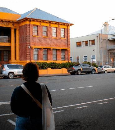 Visitor standing in front of the Mackay Court House, showcasing the historical sites explored on Anytime Tours’ walking tours.